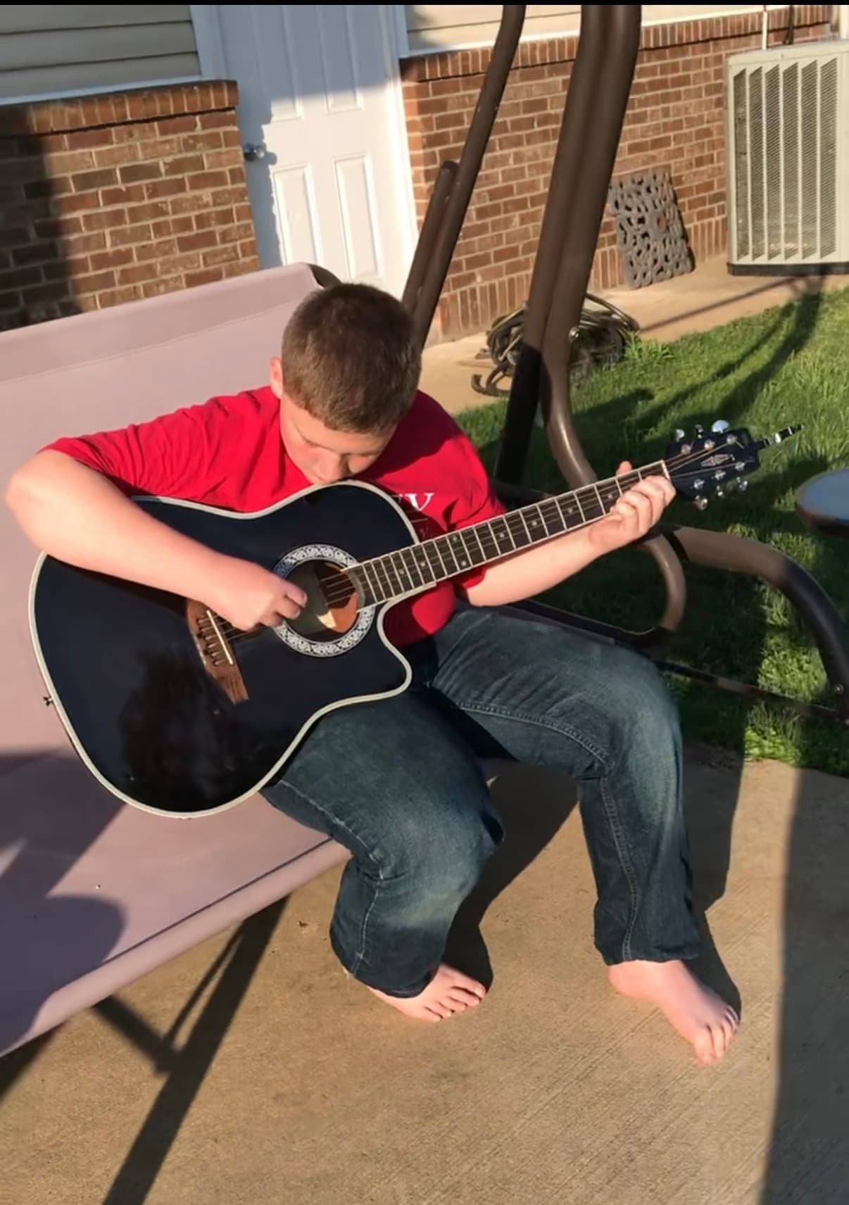 Young Jarrett with acoustic guitar